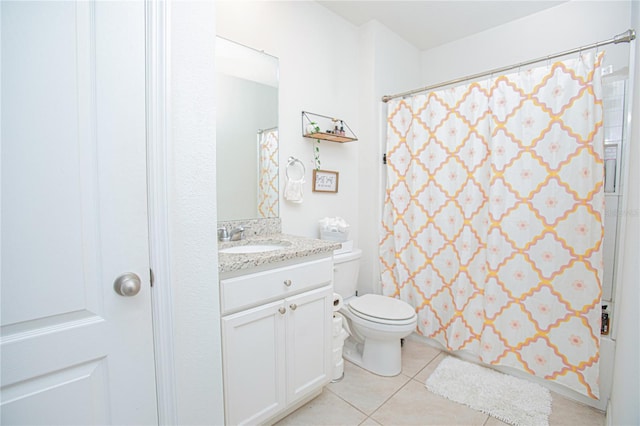 bathroom with walk in shower, vanity, toilet, and tile patterned flooring