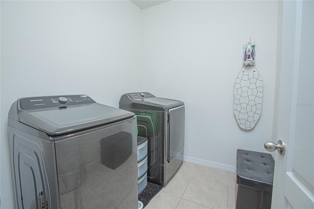 laundry room with light tile patterned floors and independent washer and dryer