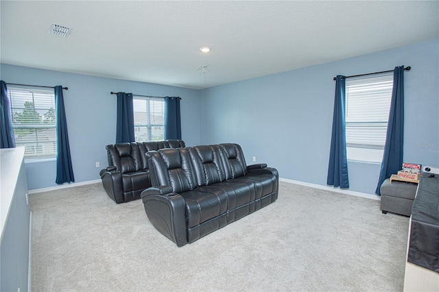 living room with a wealth of natural light and light colored carpet