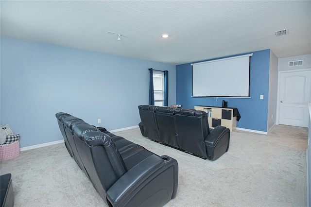 home theater room with carpet flooring and a textured ceiling