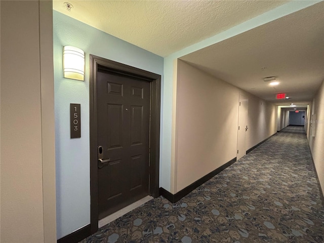 hall with a textured ceiling