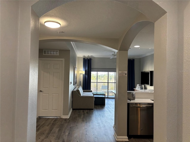 hallway featuring ornamental molding, dark hardwood / wood-style floors, and a textured ceiling