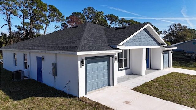 view of side of home with a garage, a yard, and cooling unit