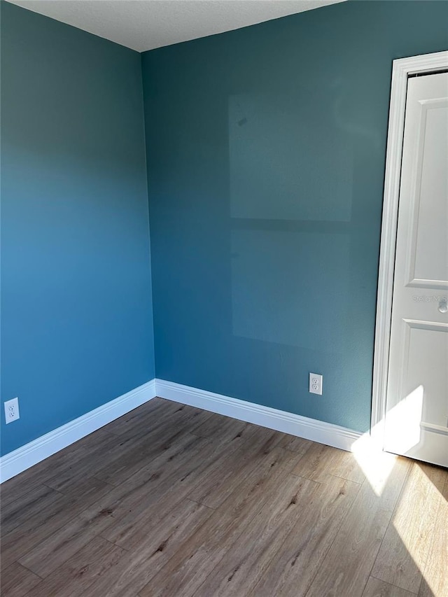 empty room featuring hardwood / wood-style flooring