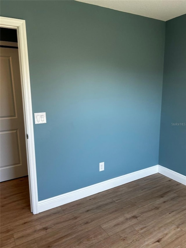 empty room with wood-type flooring