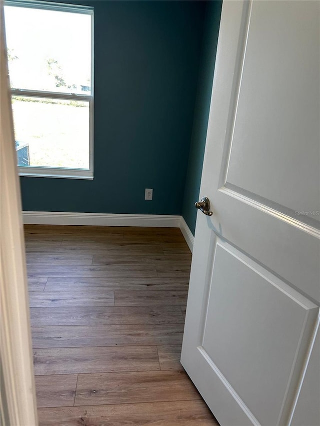 unfurnished room with light wood-type flooring