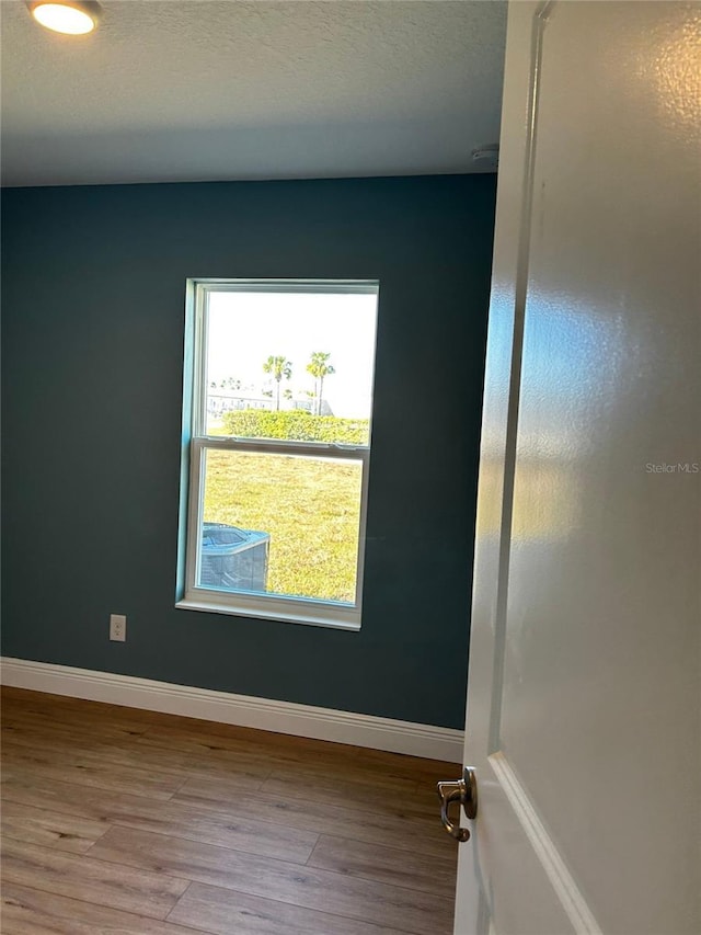 empty room with light hardwood / wood-style floors