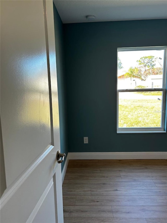 unfurnished room featuring hardwood / wood-style flooring