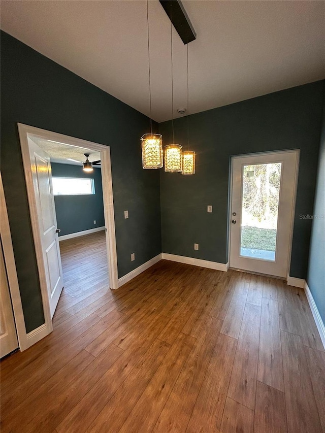 unfurnished dining area featuring hardwood / wood-style floors