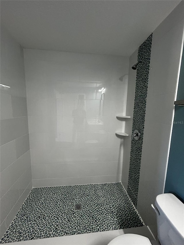 bathroom featuring toilet and walk in shower