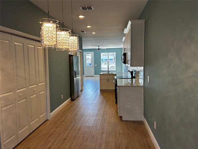 interior space with sink and light wood-type flooring