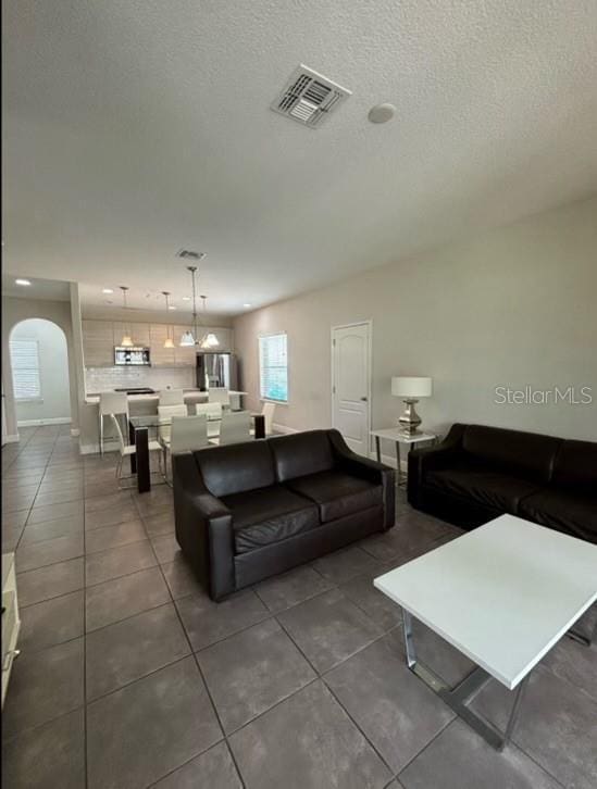 living room featuring dark tile patterned flooring