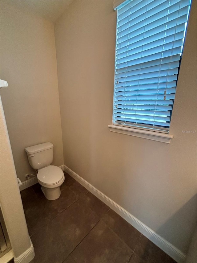 bathroom featuring tile patterned flooring and toilet