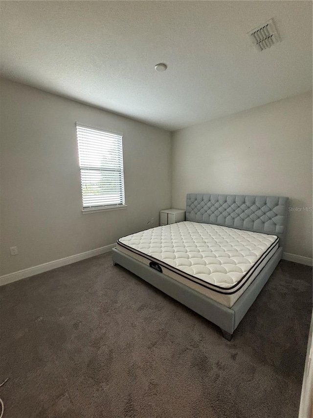 bedroom featuring dark carpet