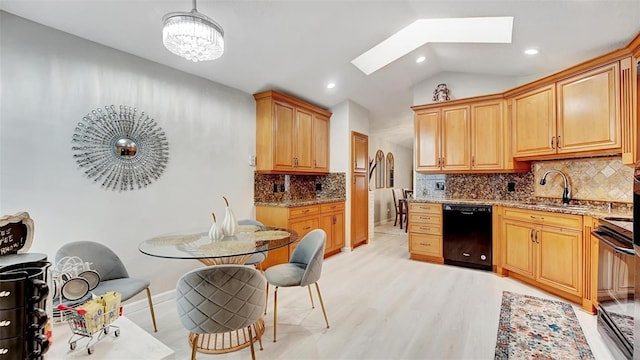 kitchen featuring light stone counters, range, black dishwasher, and vaulted ceiling with skylight