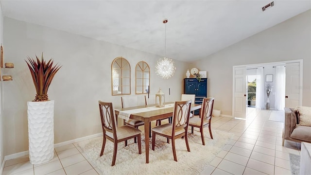 dining space with light tile patterned flooring, lofted ceiling, and a chandelier