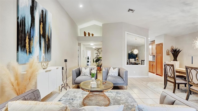 living room with light tile patterned flooring and vaulted ceiling