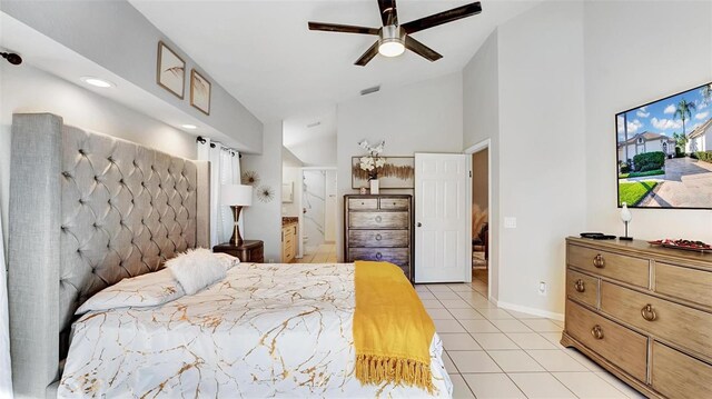 bedroom with ceiling fan, lofted ceiling, and light tile patterned floors