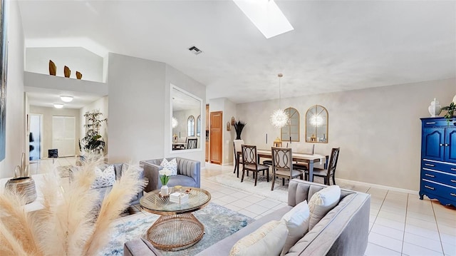 tiled living room featuring lofted ceiling with skylight