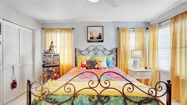 tiled bedroom with a closet and ceiling fan