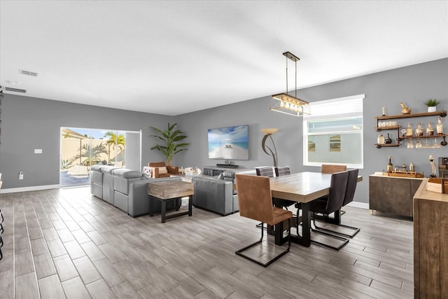 dining space featuring light hardwood / wood-style flooring and a wealth of natural light