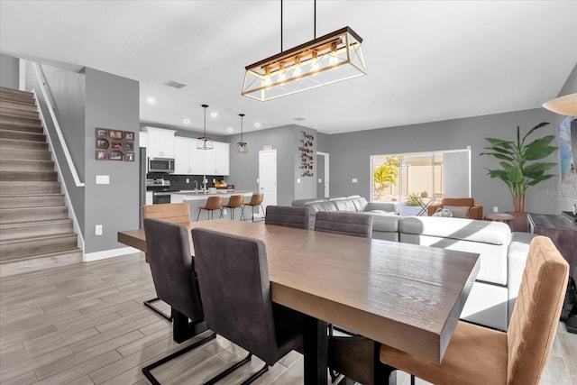 dining space with light hardwood / wood-style flooring