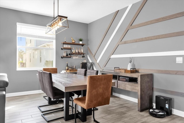 dining room with hardwood / wood-style flooring and a notable chandelier