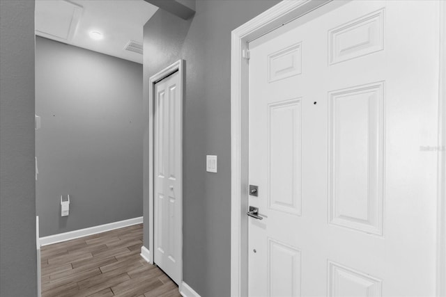 hallway with light hardwood / wood-style flooring