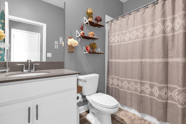 bathroom featuring walk in shower, vanity, and toilet