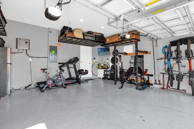 garage featuring a garage door opener, stainless steel fridge, and electric panel