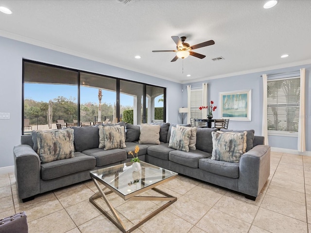 tiled living room with ceiling fan, ornamental molding, and a textured ceiling