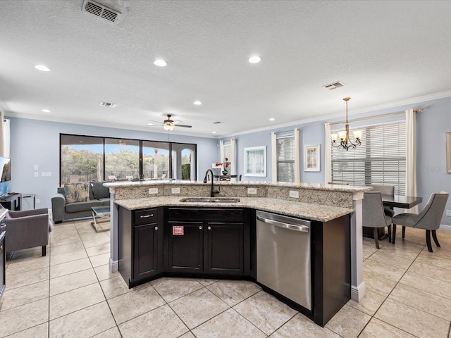 kitchen featuring pendant lighting, stainless steel dishwasher, sink, and a center island with sink