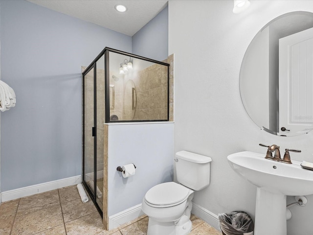 bathroom with tile patterned floors, toilet, an enclosed shower, and sink