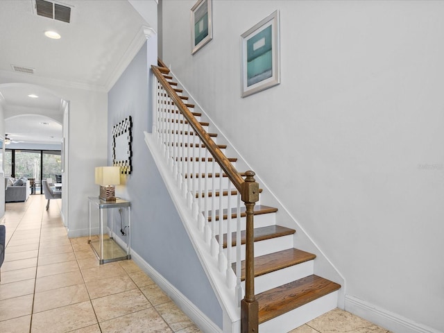 stairway featuring crown molding, tile patterned floors, and ceiling fan