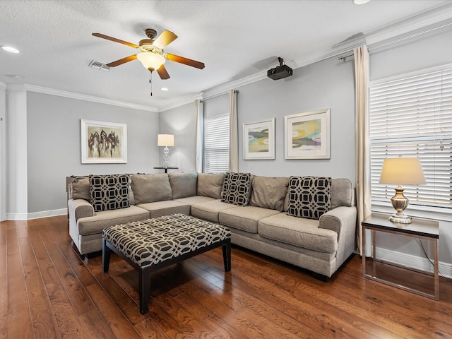 living room with crown molding, dark wood-type flooring, a textured ceiling, and ceiling fan