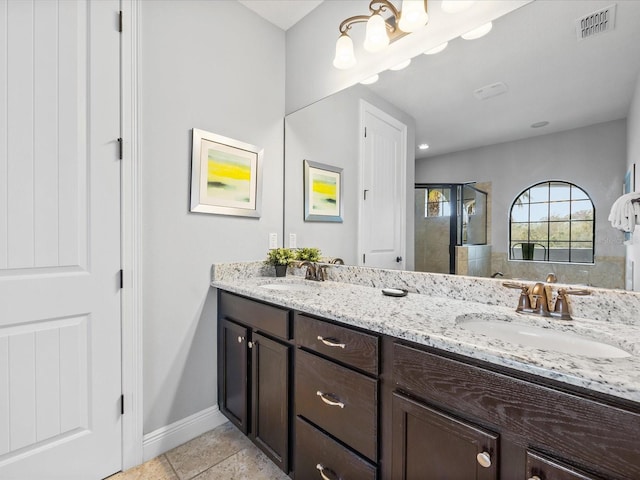 bathroom featuring tile patterned floors, an enclosed shower, and vanity