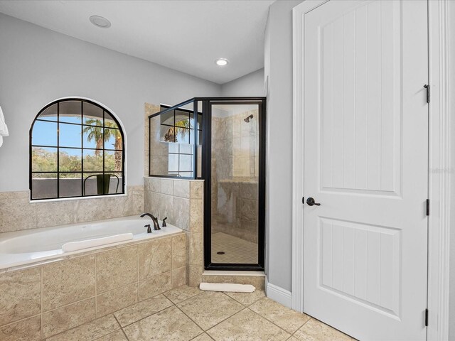 bathroom featuring tile patterned flooring and shower with separate bathtub