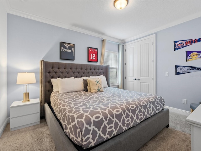 carpeted bedroom featuring ornamental molding and a closet