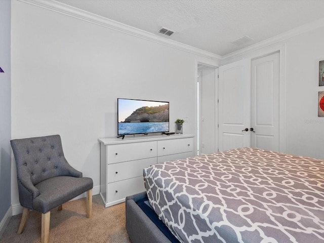 bedroom featuring ornamental molding, light colored carpet, and a textured ceiling