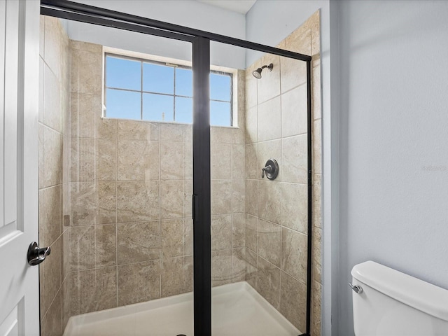 bathroom with an enclosed shower and toilet