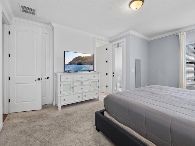 bedroom with ornamental molding, light carpet, and a textured ceiling