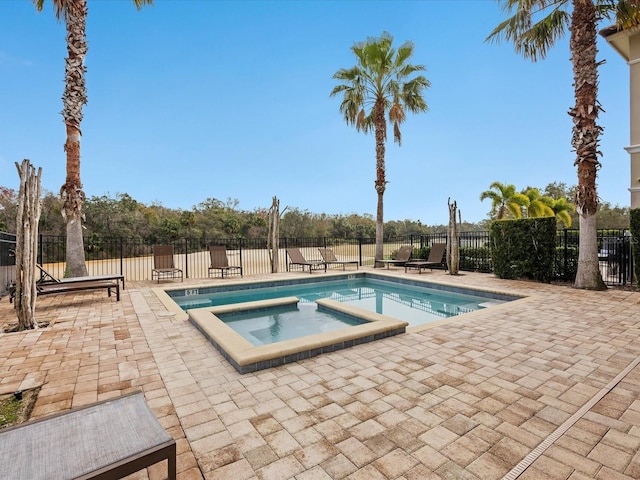 view of pool featuring an in ground hot tub and a patio