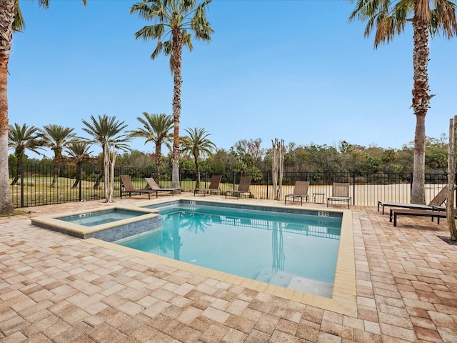 view of pool with an in ground hot tub and a patio