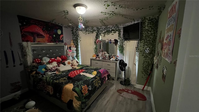 bedroom with hardwood / wood-style flooring and a textured ceiling