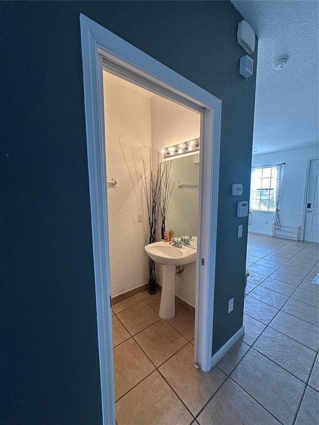 bathroom with tile patterned floors and a textured ceiling