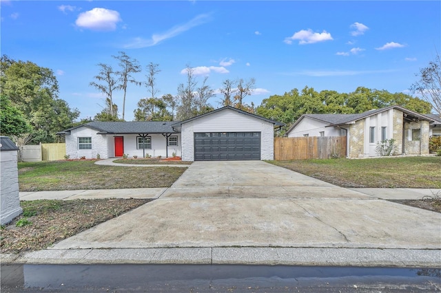 ranch-style house featuring a garage and a front lawn