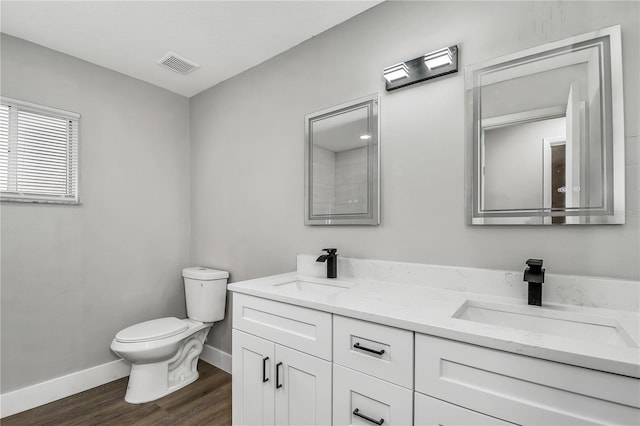 bathroom with vanity, toilet, and hardwood / wood-style floors