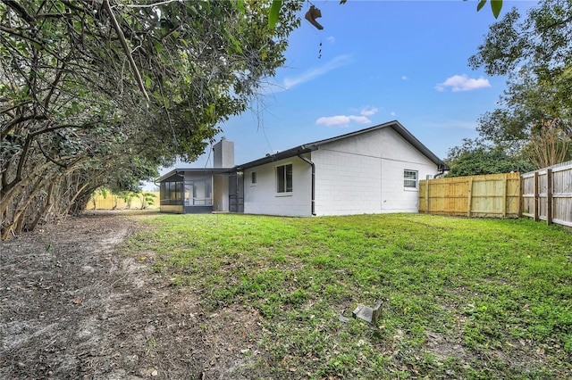 rear view of property featuring a yard