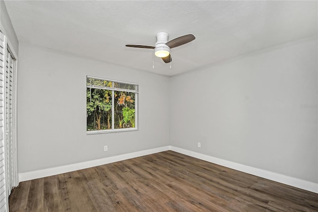 spare room featuring dark hardwood / wood-style flooring and ceiling fan