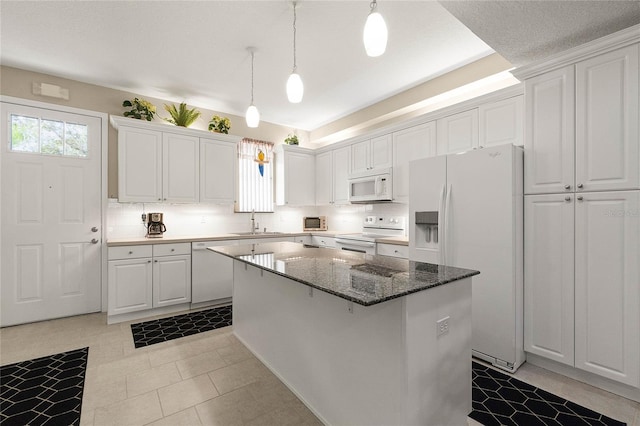 kitchen with sink, white appliances, white cabinets, and a kitchen island